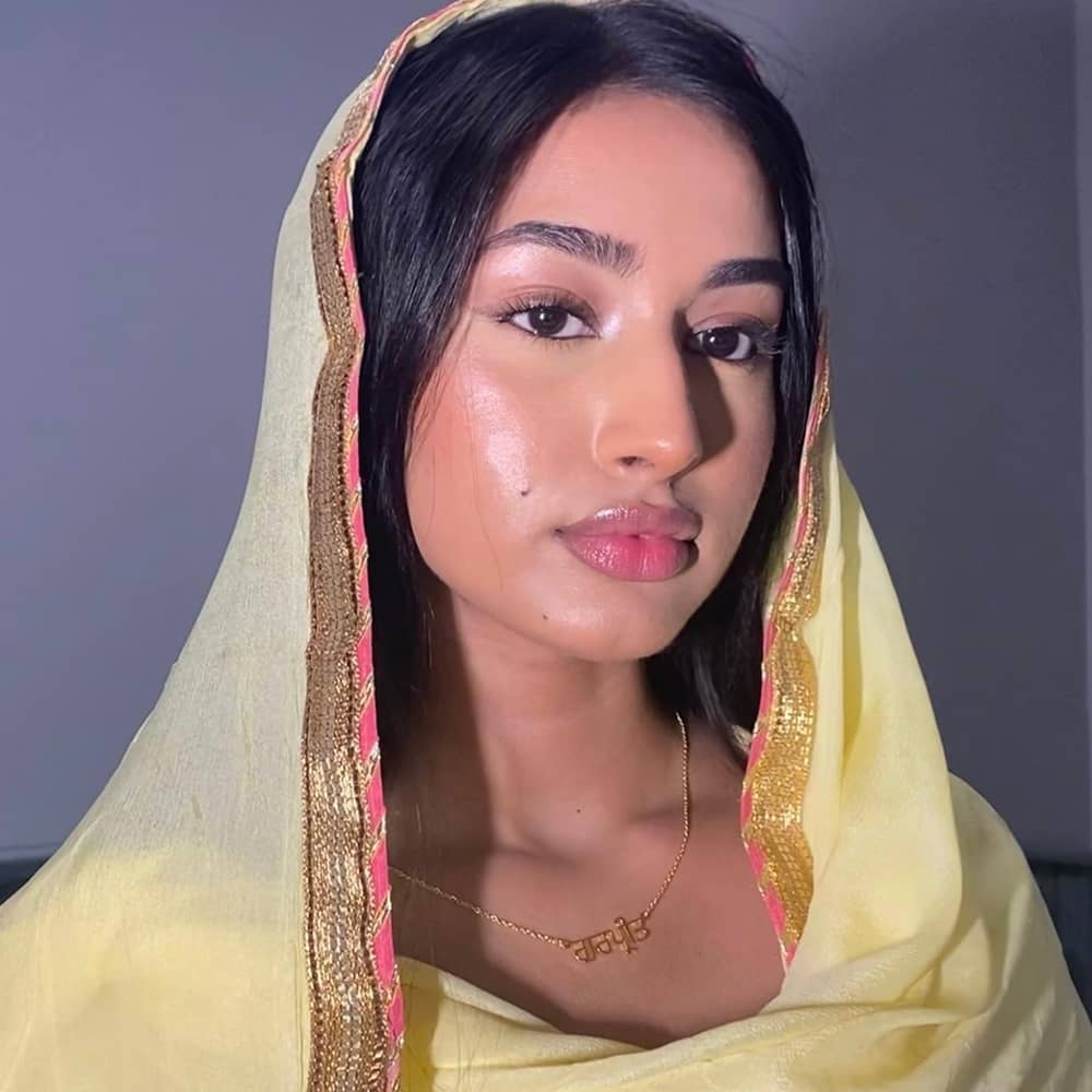 Influencer Gurpreet wearing Punjabi name necklace with traditional yellow Punjabi suit and chunni