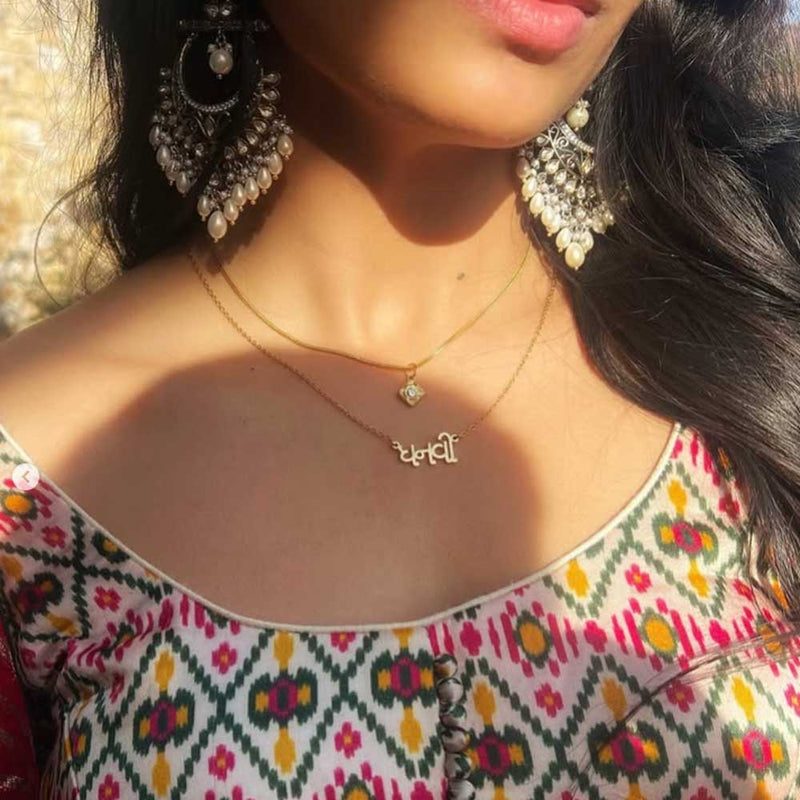 Close-up of influencer Dhanvi Patel wearing a gold Gujarati name necklace paired with a traditional lehenga