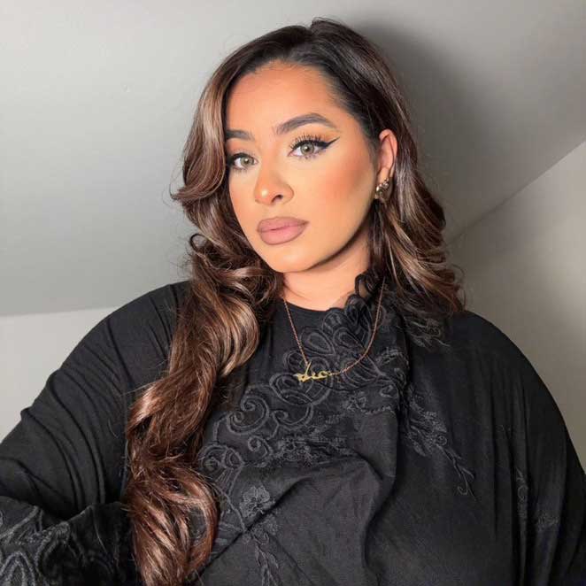 Influencer Inayah wearing gold Urdu name necklace paired with black salwar kameez