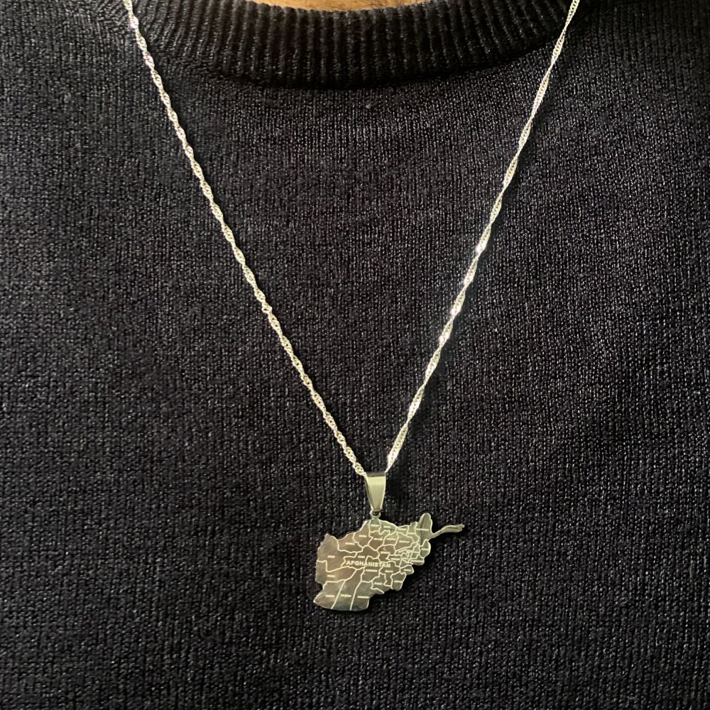 man wearing afghanistan map necklace in stainless steel silver with the city engravings