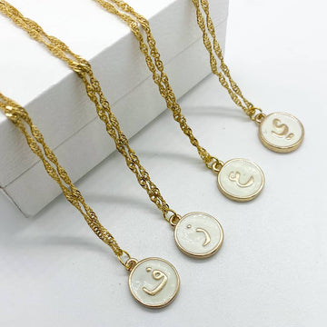 white enamel and 18ct gold plated initial pendant necklace with letters in arabic