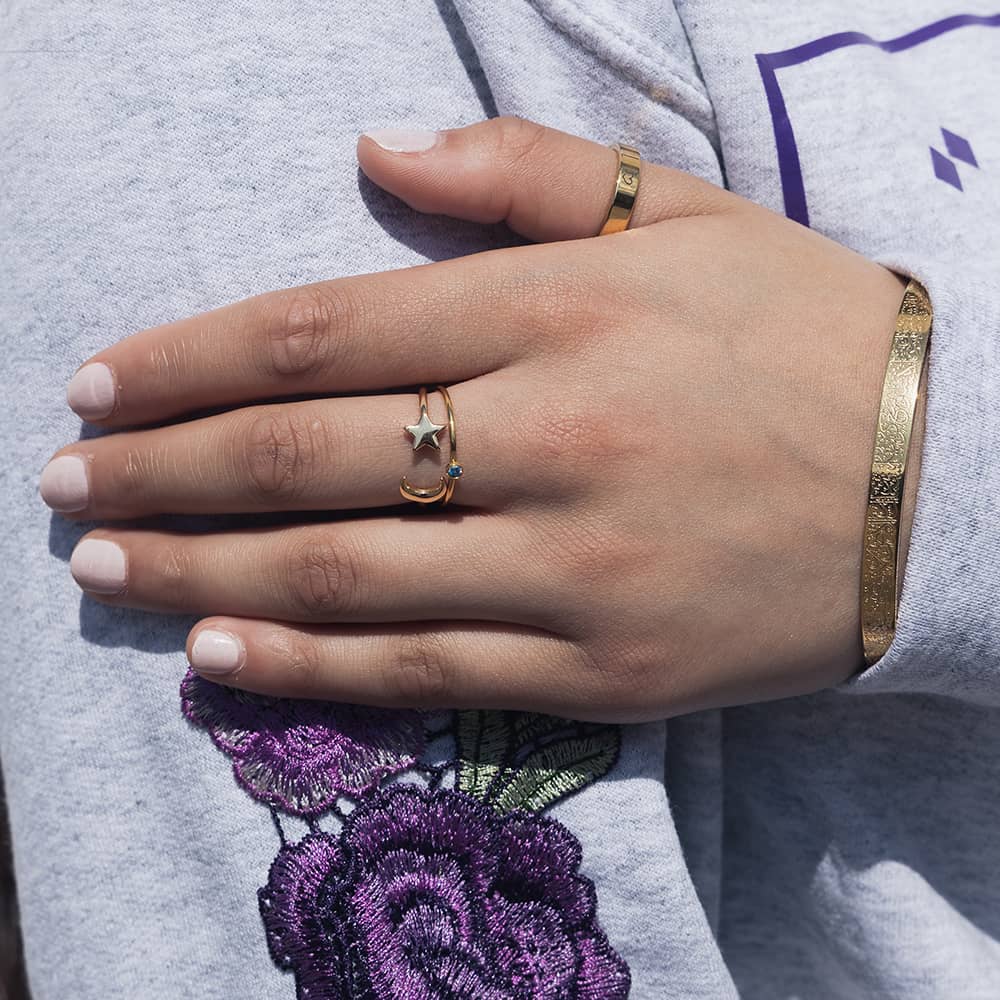 woman wearing 18ct gold jewellery including bangle and resizable rings