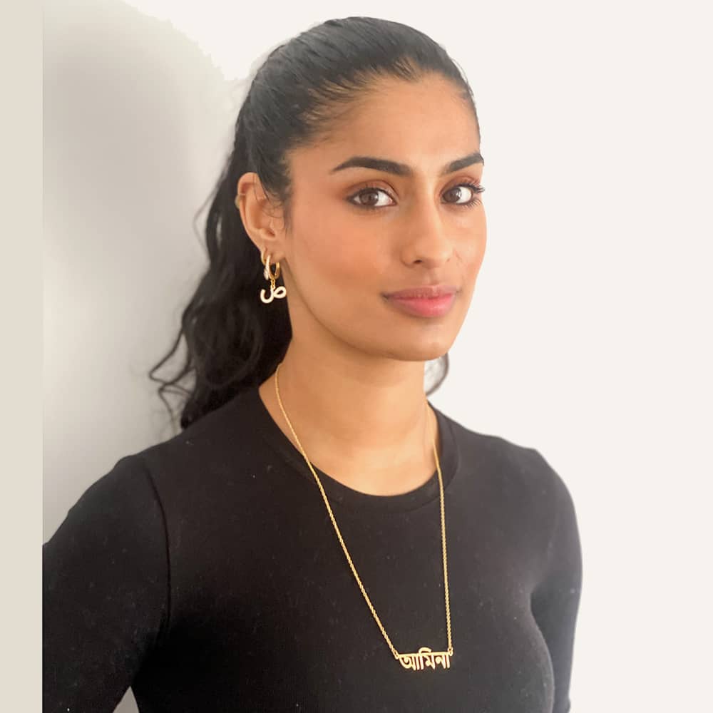 Eleisha wearing custom gold name necklace in Bengali script