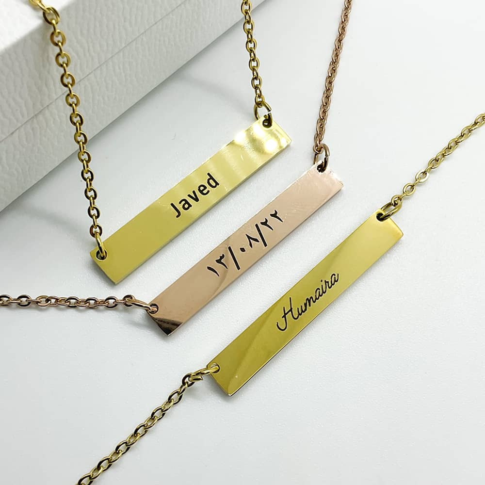 bar necklace in 18k gold and rose gold with engraving of name and dates in english and arabic