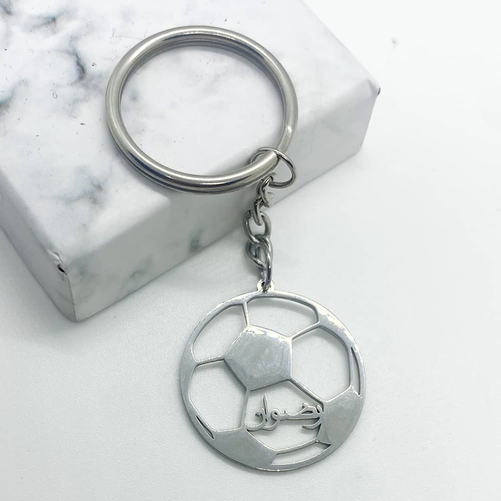 football design keychain for men in silver with custom name in arabic