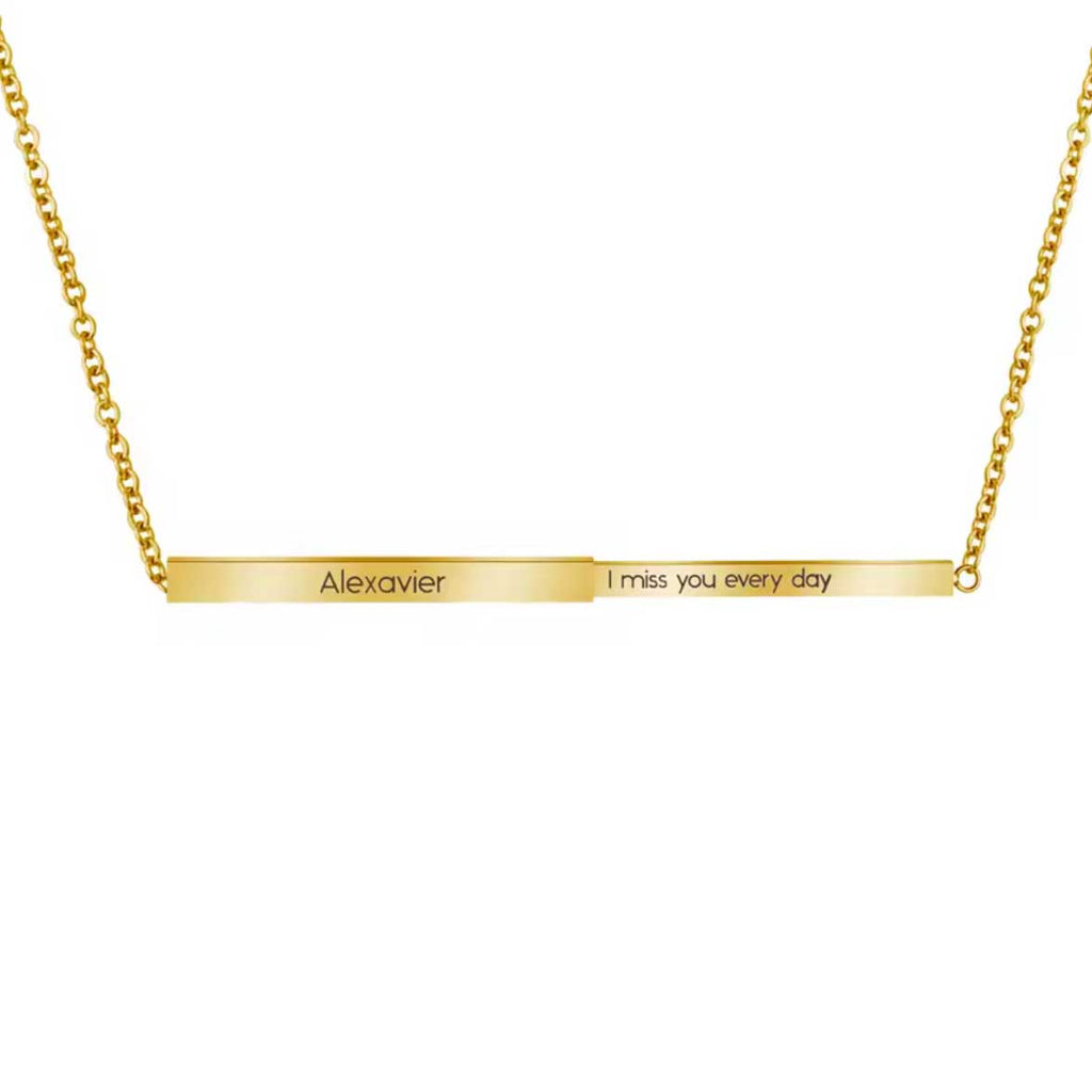Gold necklace with engraved message on a white background