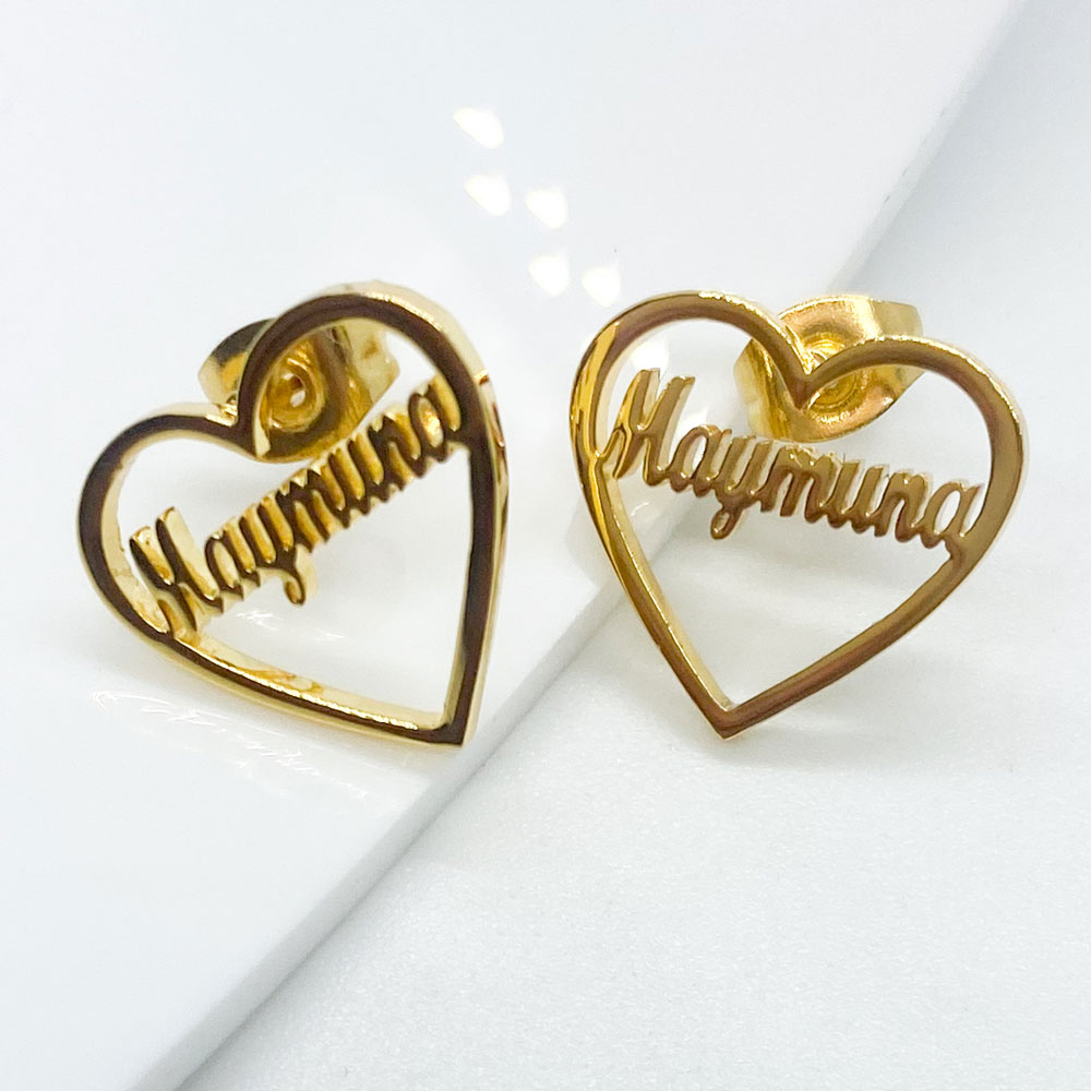 close up of a pair of custom name heart earrings with name in any language