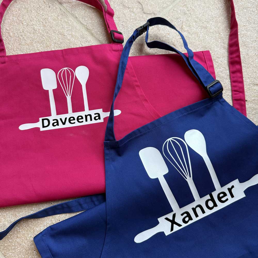 sibling matching childrens aprons with personalised name in pink and blue