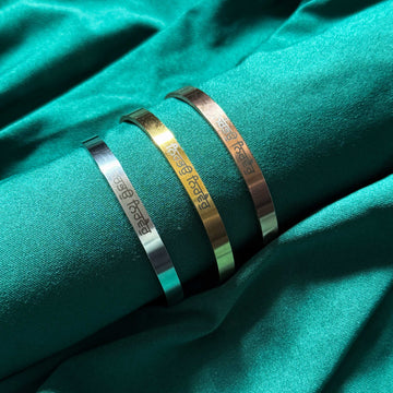 Video of ArtByZakia engraving the adjustable cuff bangle in gold, rose gold and black with Punjabi quote