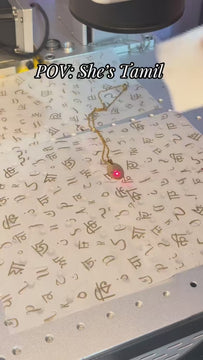behind the scenes of a pendant being engraved with a gloriosa lily line art drawing design