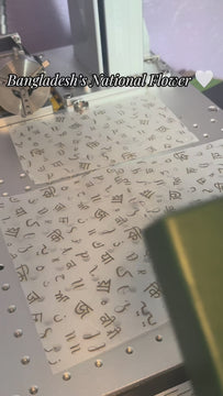 VIDEO by ArtByZakia revealing white water lily line art drawing on necklace with name engraved in Bangla on the back