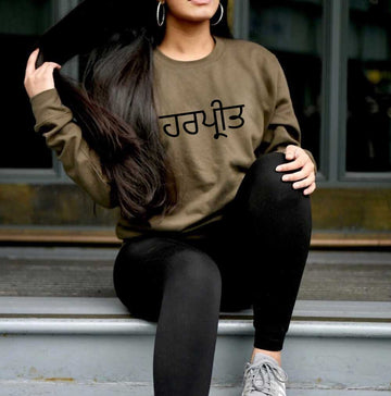 woman wearing forest green sweatshirt with personalised punjabi name in black