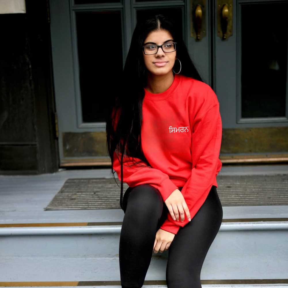 woman wearing red sweatshirt with white personalised name in punjabi