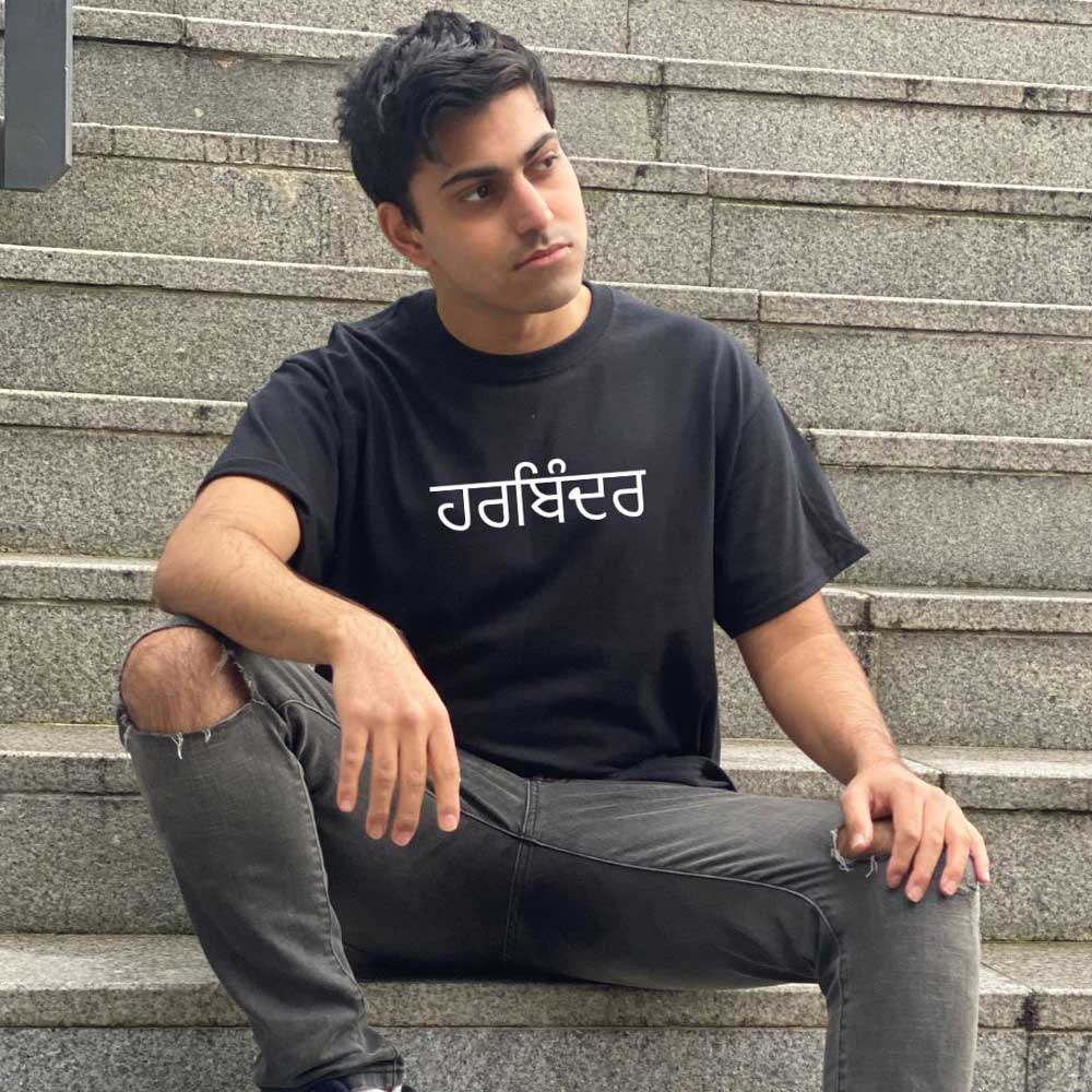 man wearing black tshirt with punjabi name in white