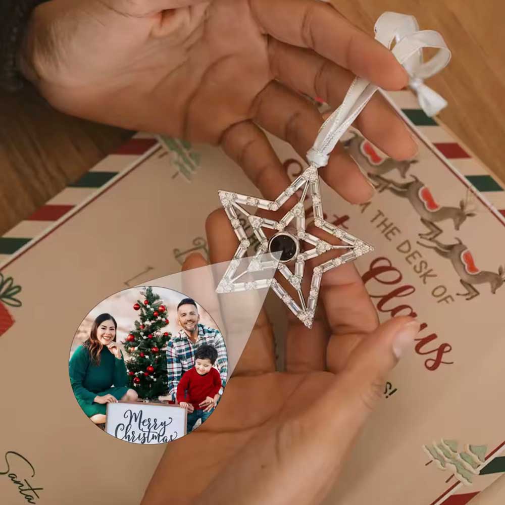 woman holding star hanging ornament for christmas tree with hidden family photo inside