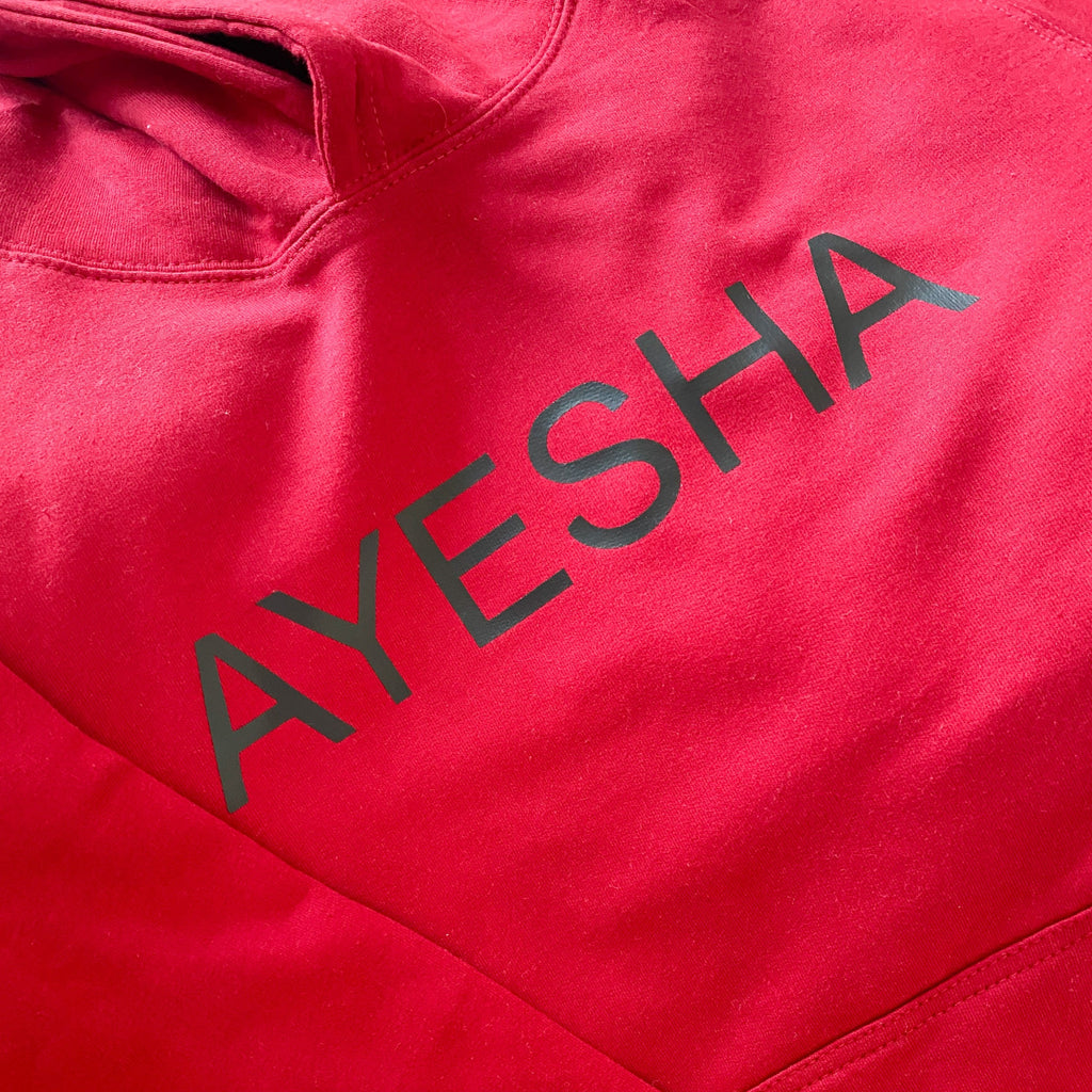 close up of red hoodie with black printed English name