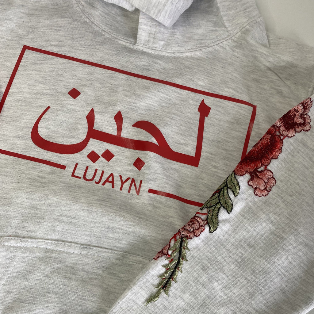 ash grey hoodie with red design and Arabic and English name with red floral sleeve embroidery!