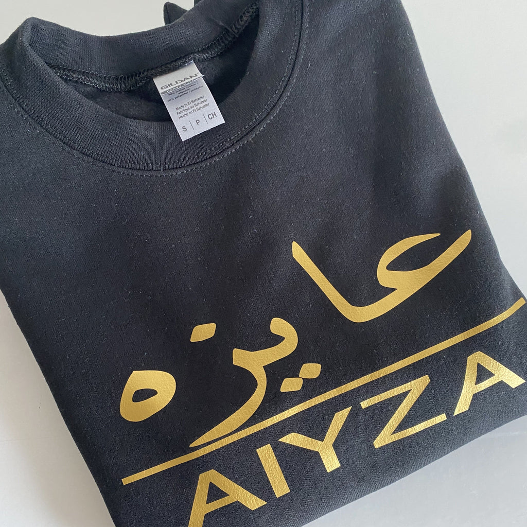 black sweatshirt with metallic gold design Arabic and English name