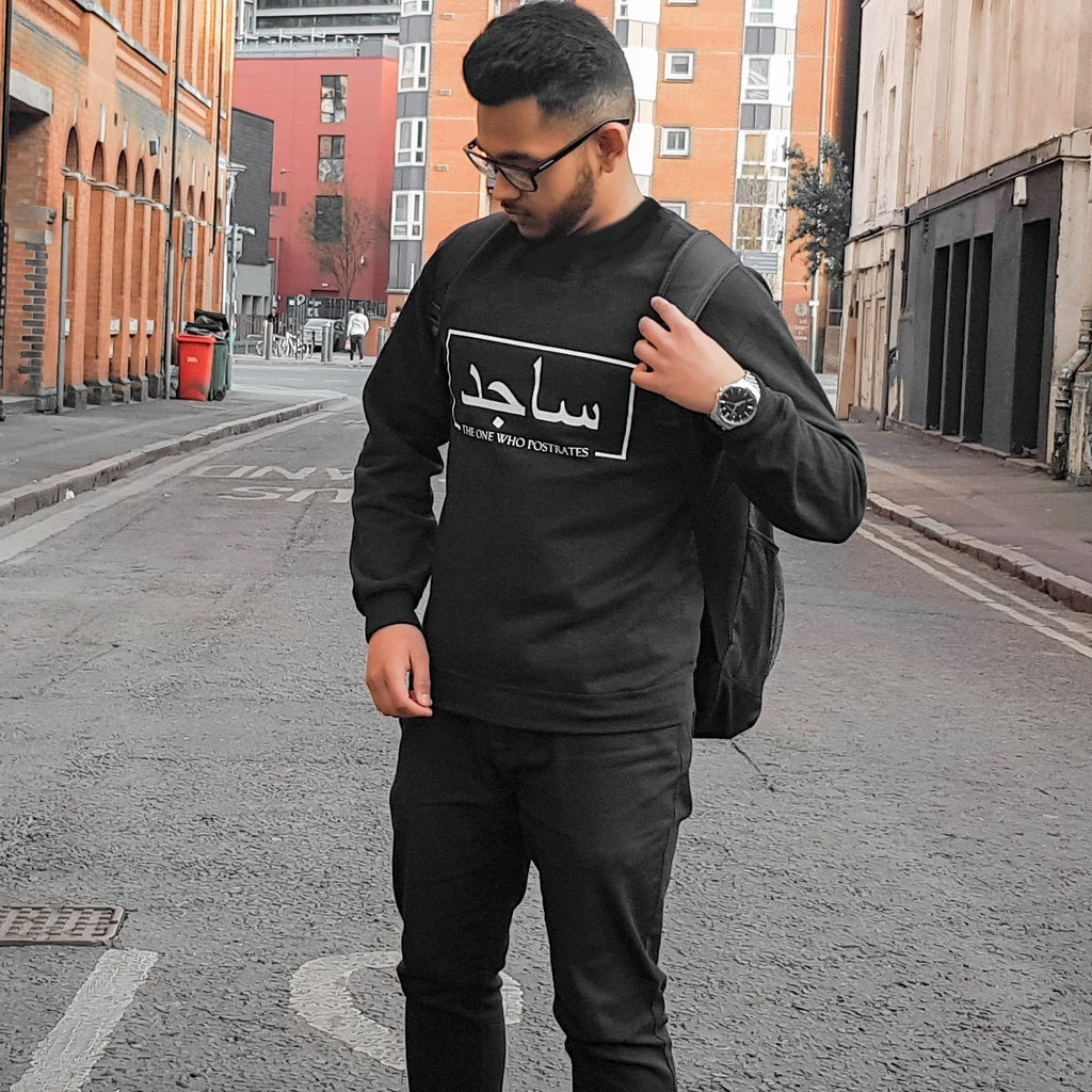 black sweatshirt with white box design including Arabic and English name printed across the chest