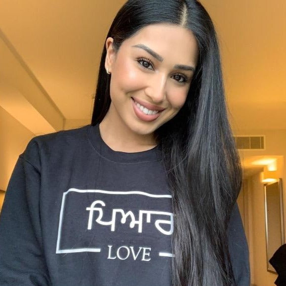 Charcoal sweatshirt with white box design including Punjabi and English text printed across the chest