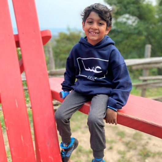 customer photo - navy blue hoodie with white design Arabic and English name across chest